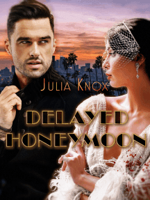 Delayed Honeymoon by Julia Knox. Woman in feathery white gown wearing short jeweled veil with arms crossed, next to man wearing all black. Cityscape background